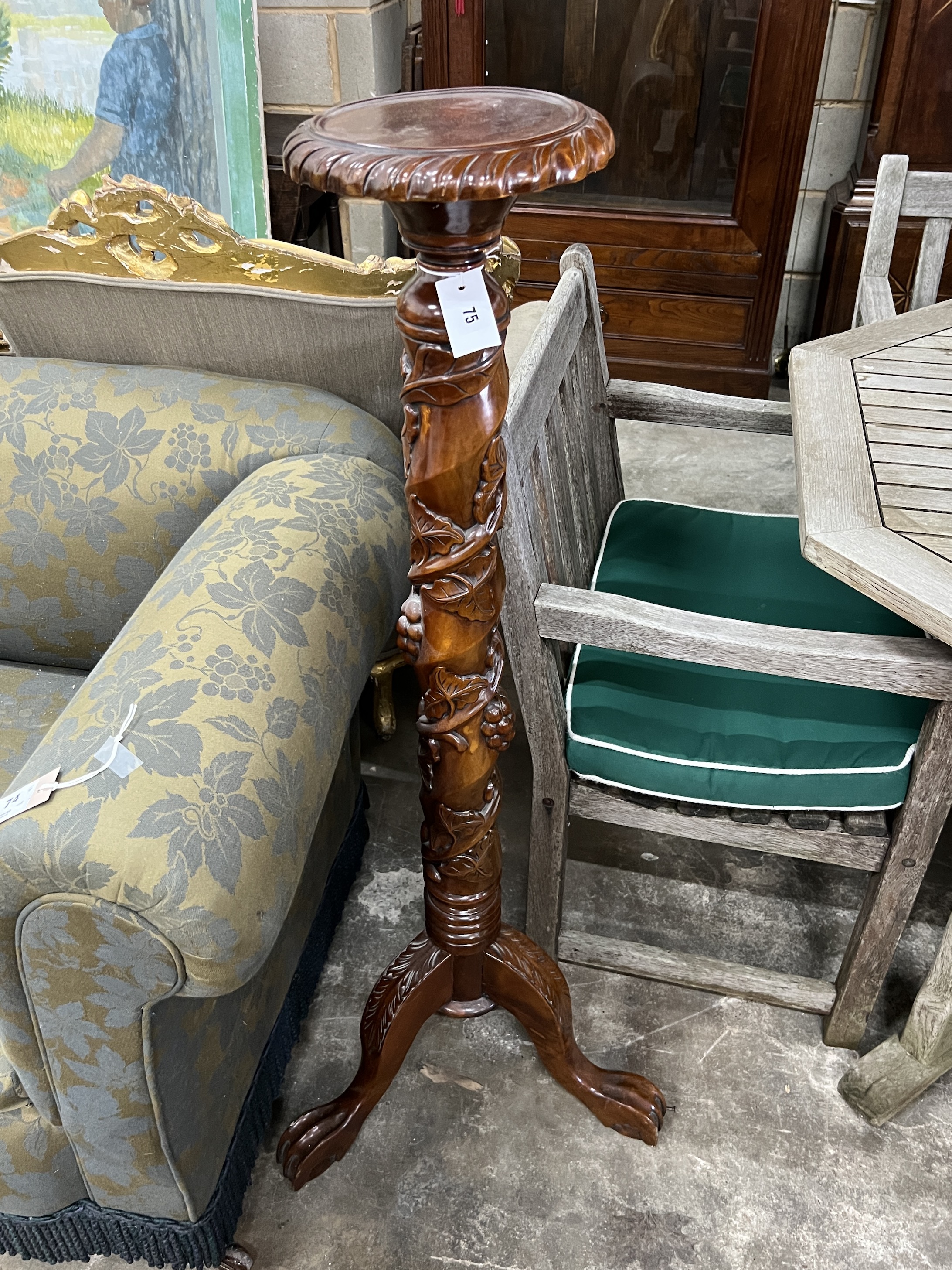 A Victorian style mahogany carved torchere stand, height 116cm